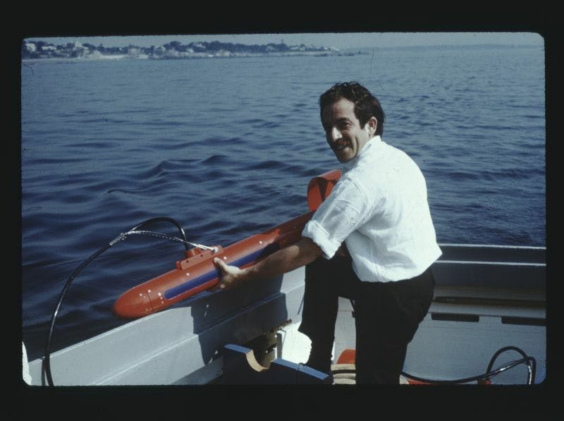 Martin Klein near water holding a side scan sonar device