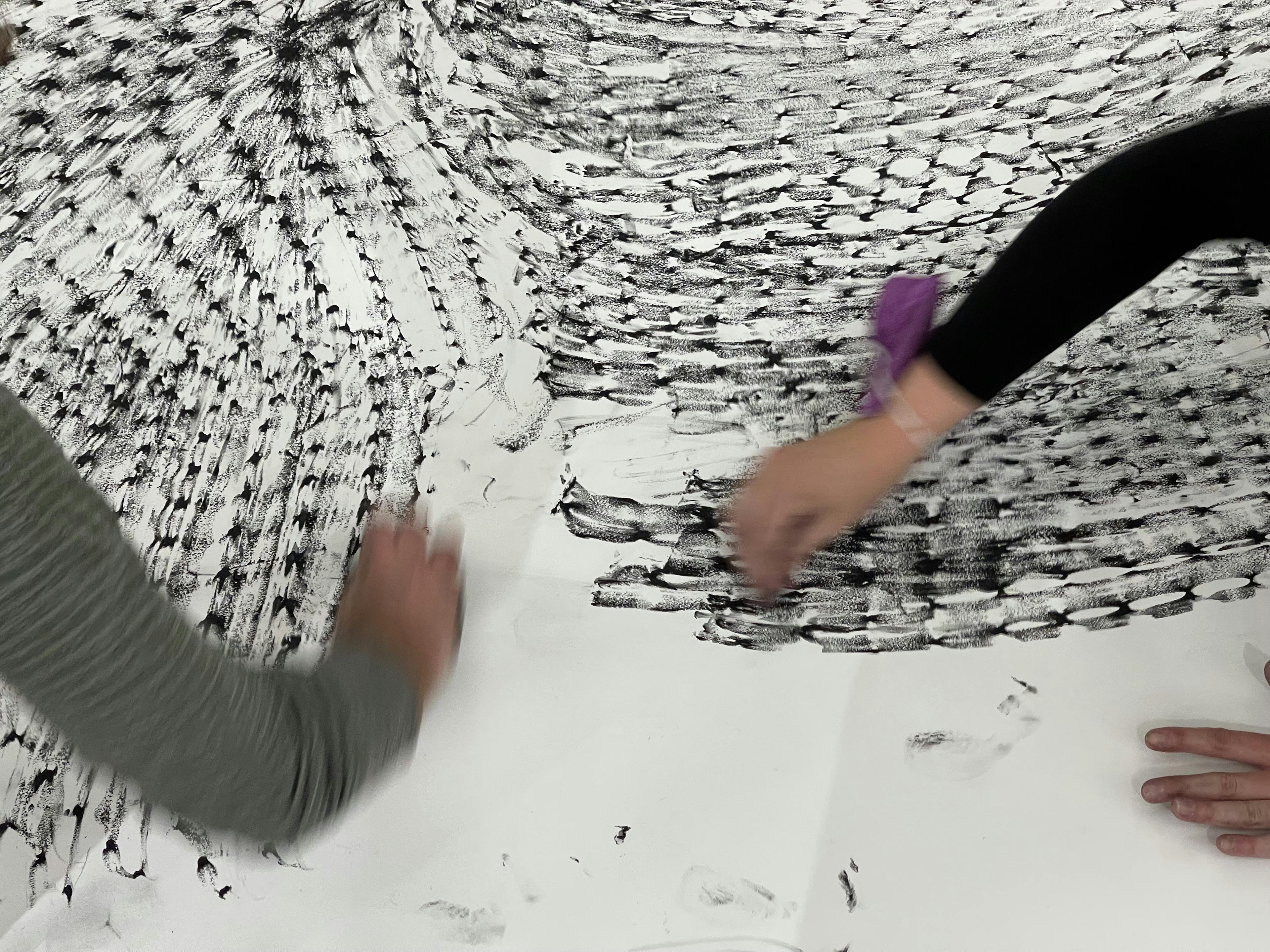 Image of people hands drawing on paper.