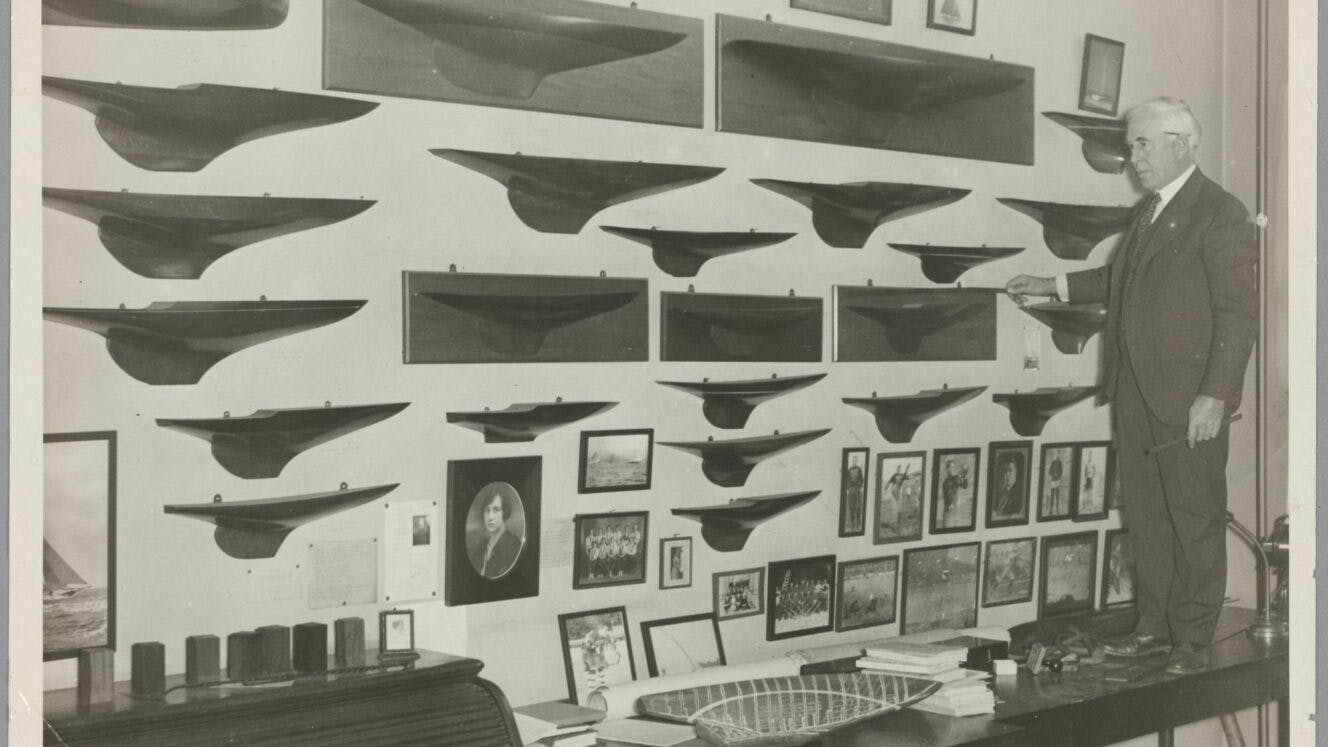 George Owen with a wall of half-hull models