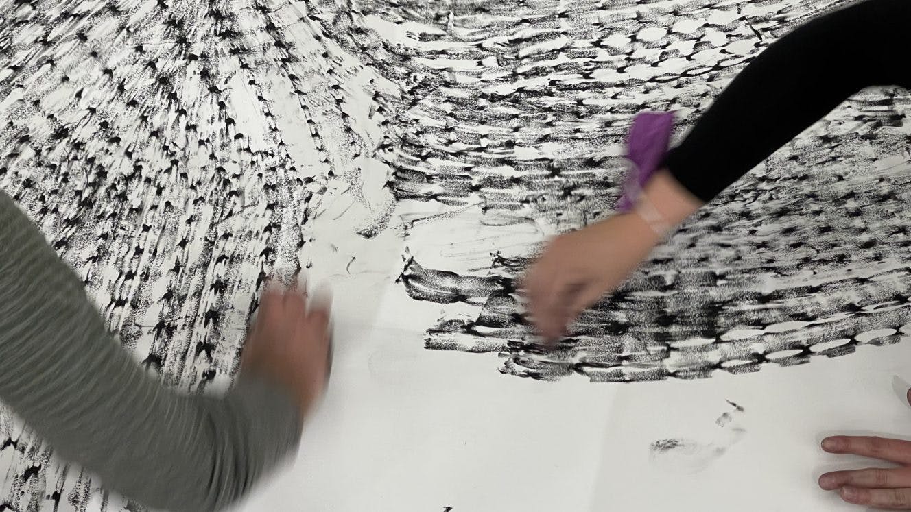 Image of people hands drawing on paper.